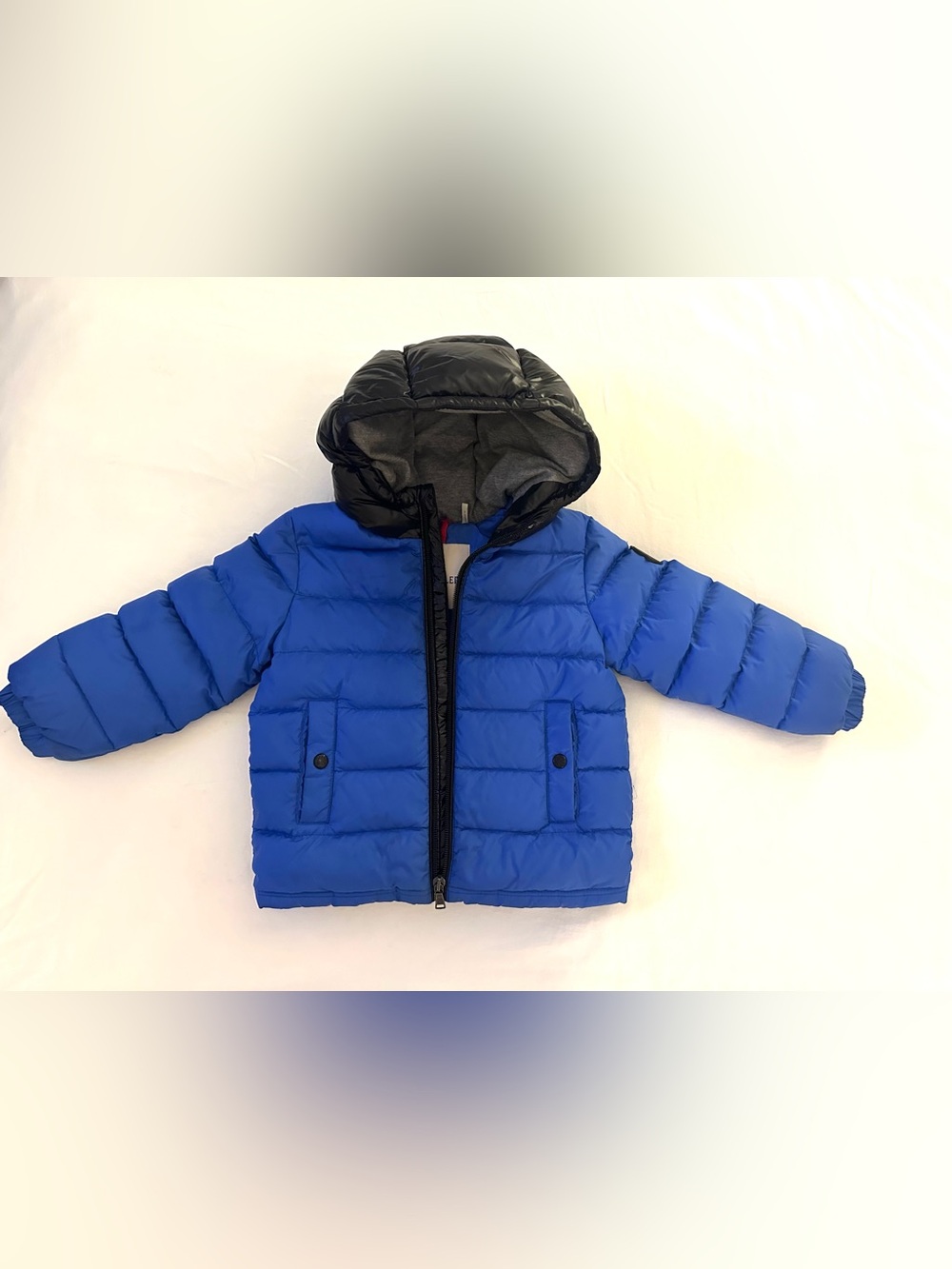 Moncler Kids Blue Puffer Jacket with Black Hood and Trim.